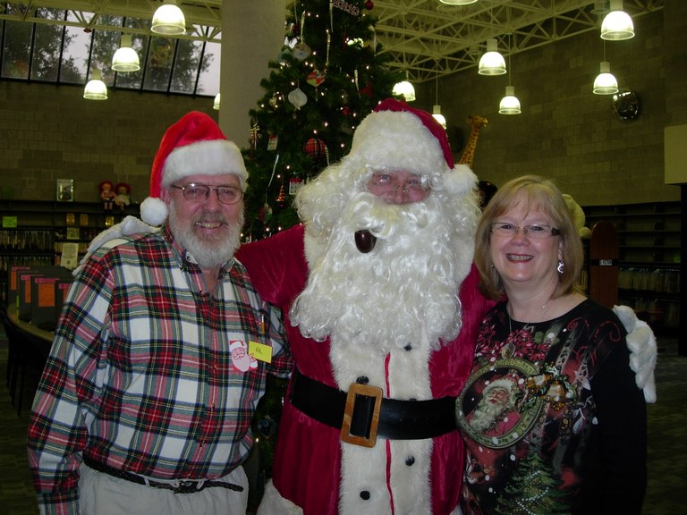 Santa with children's librarian, Sue Lintelman and volunteer, Al Brandli